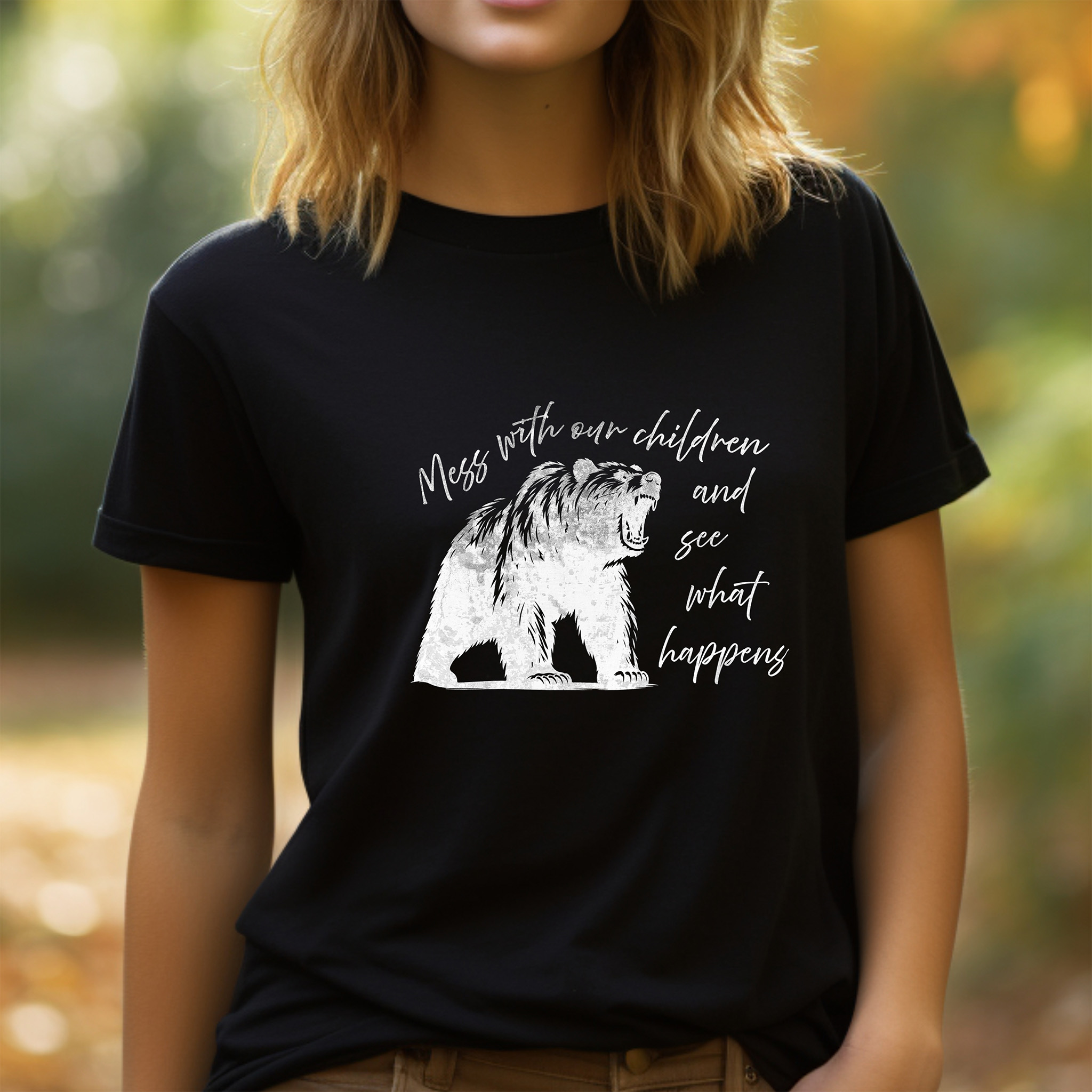 Lady wearing black t-shirt "Mess with our children and see what happens" in white with White sketch of mother bear roaring